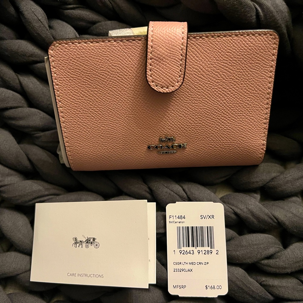 Coach textured leather medium wallet in ballet pink.